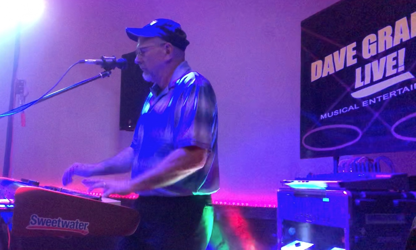 Dave Graham Live performance setup featuring keyboards, guitar, lighting, and professional equipment